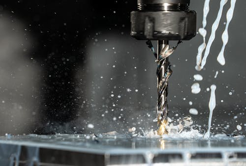 Free Close Up Phot of a CNC Milling Machine with Metalworking Fluid Stock Photo